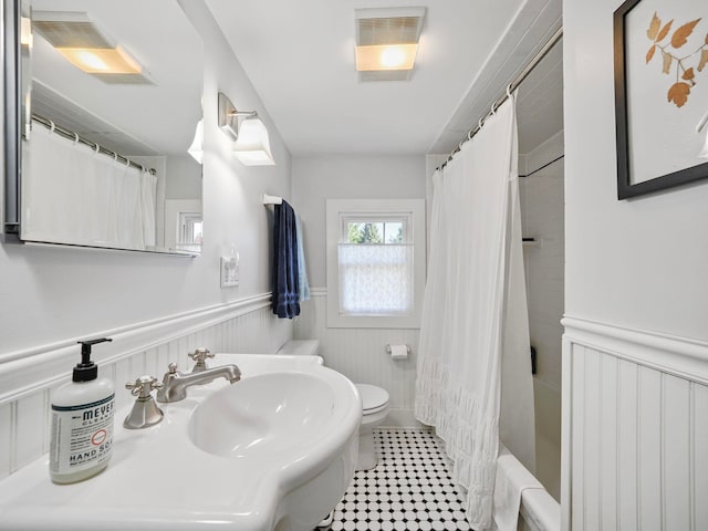 full bathroom with sink, shower / bath combo, and toilet