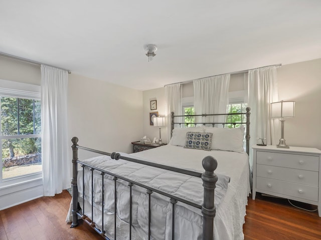 bedroom with dark wood-type flooring