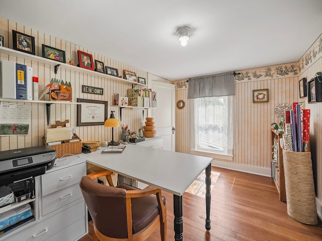 home office featuring wooden walls and light hardwood / wood-style flooring