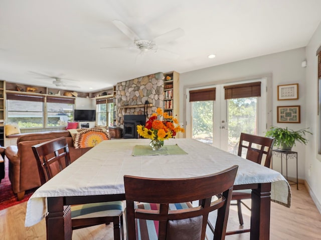 dining room with a wealth of natural light, french doors, ceiling fan, and light hardwood / wood-style floors