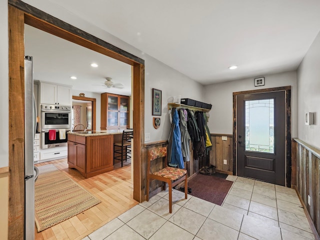 entryway with light wood-type flooring and ceiling fan