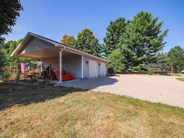 exterior space featuring a carport and a lawn