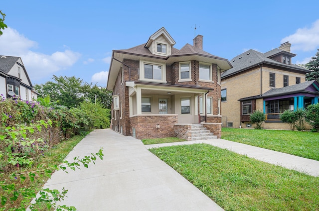 victorian home featuring a front yard and covered porch