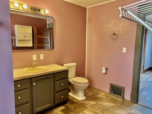 bathroom featuring vanity and toilet