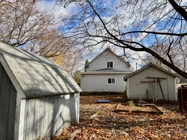 view of side of property with a shed