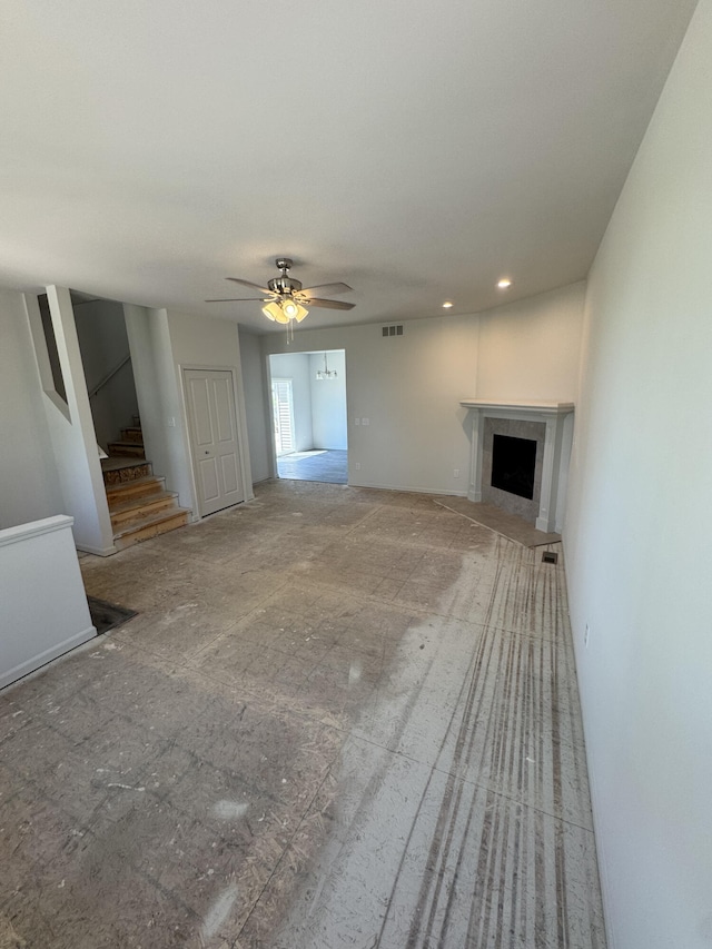 411 Mason Run Blvd, Monroe, MI 48162 - unfurnished living room featuring a fireplace, stairs, ceiling fan, and recessed lighting