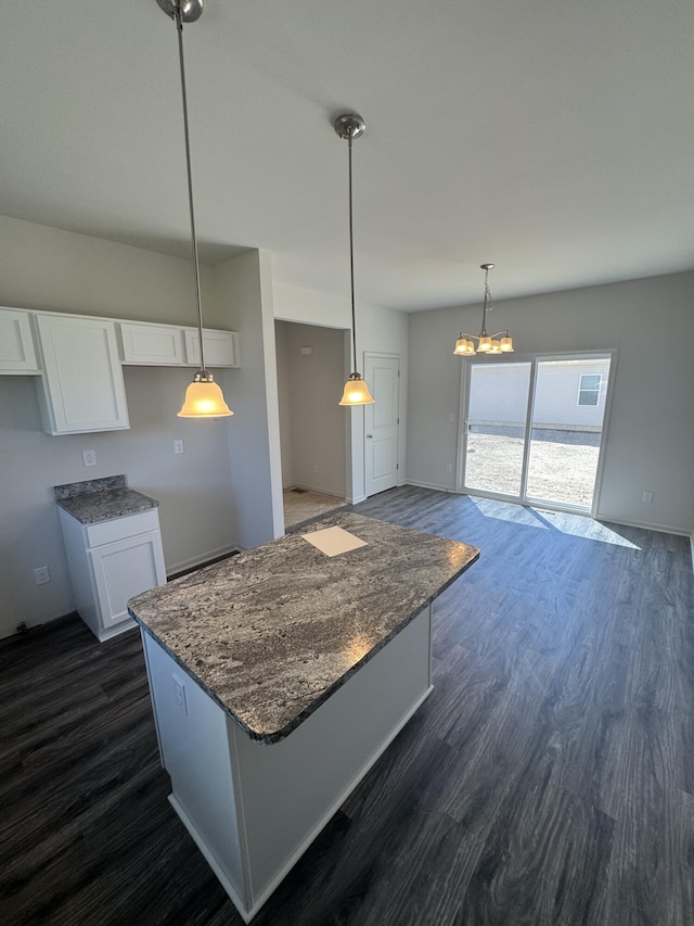 411 Mason Run Blvd, Monroe, MI 48162 - kitchen with white cabinetry, dark wood-style floors, a chandelier, dark stone countertops, and a center island