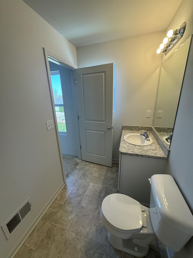 411 Mason Run Blvd, Monroe, MI 48162 - bathroom featuring toilet, vanity, and baseboards