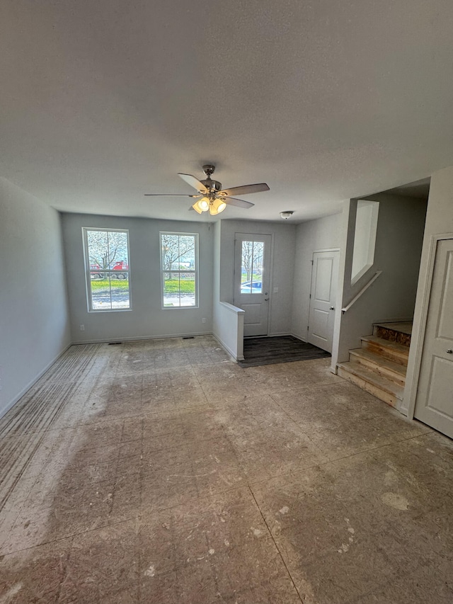 411 Mason Run Blvd, Monroe, MI 48162 - unfurnished living room with stairs and a ceiling fan