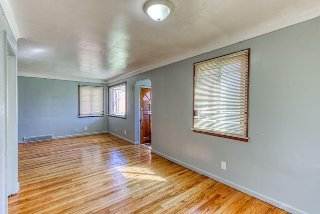 empty room with light hardwood / wood-style flooring