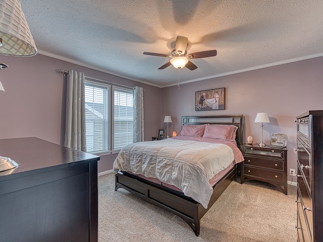 carpeted bedroom with a textured ceiling, ceiling fan, and crown molding