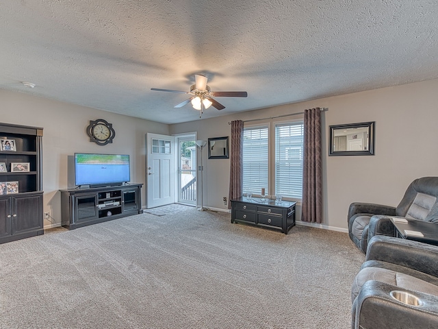 carpeted living room featuring a textured ceiling and ceiling fan