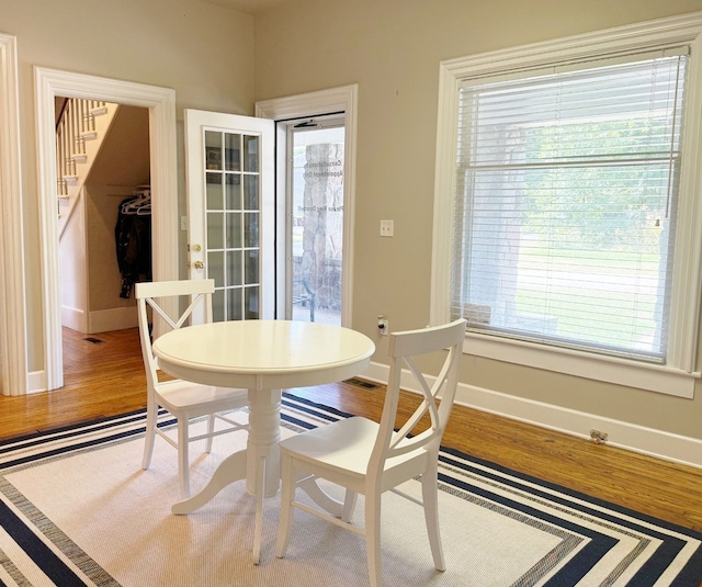 dining space with wood-type flooring