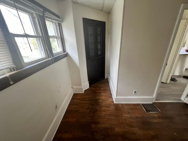 corridor featuring dark hardwood / wood-style flooring