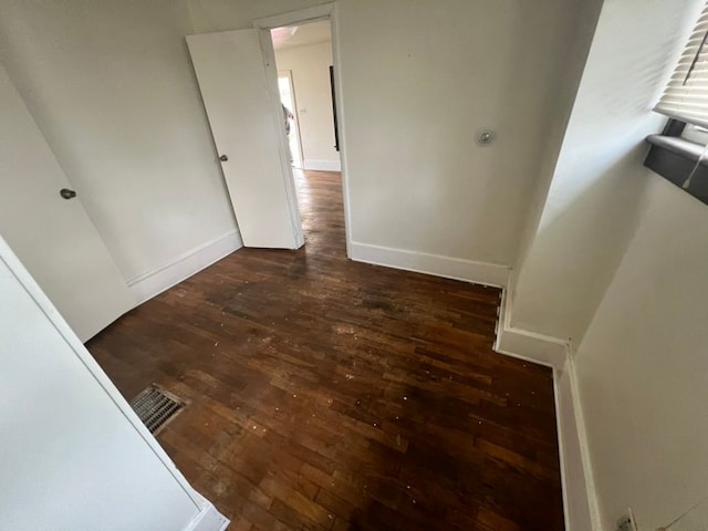 hallway with dark hardwood / wood-style floors