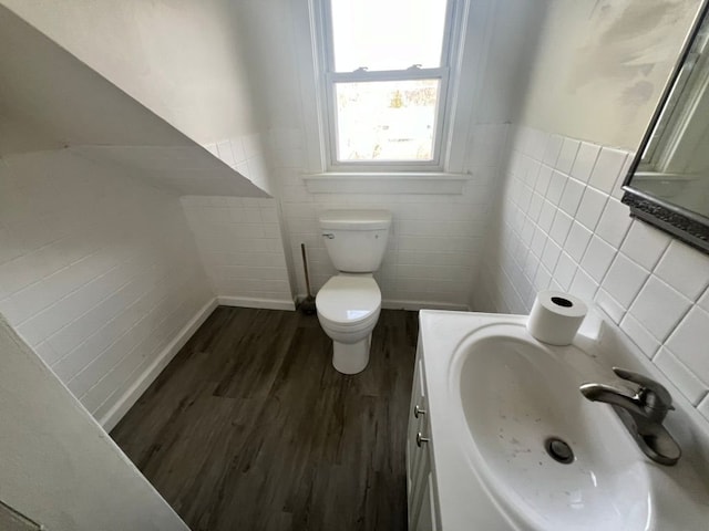 bathroom with vanity, wood-type flooring, tile walls, and toilet