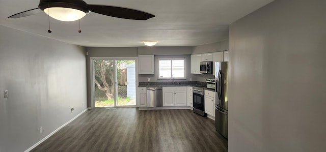 kitchen featuring white cabinetry, dark hardwood / wood-style flooring, ceiling fan, and appliances with stainless steel finishes