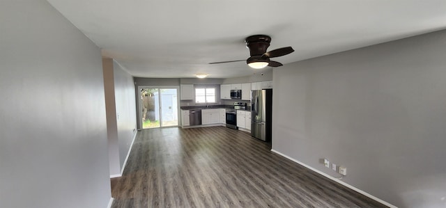 kitchen featuring white cabinets, dark hardwood / wood-style floors, ceiling fan, and stainless steel appliances