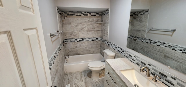 full bathroom with vanity, tiled shower / bath combo, tile walls, and toilet