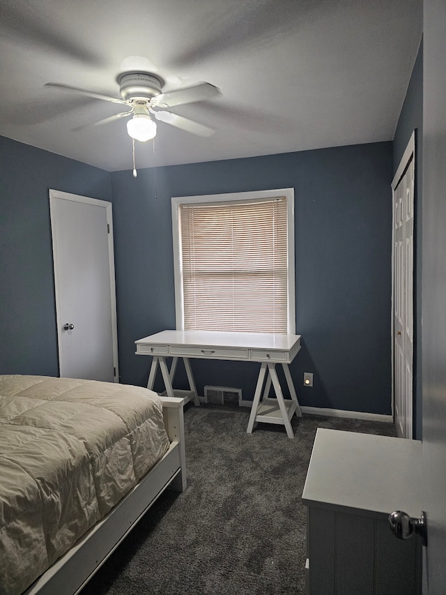 carpeted bedroom with ceiling fan and a closet