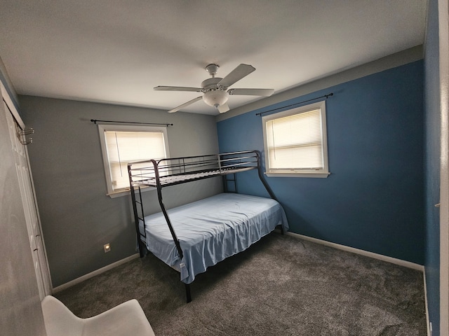 unfurnished bedroom with dark colored carpet and multiple windows