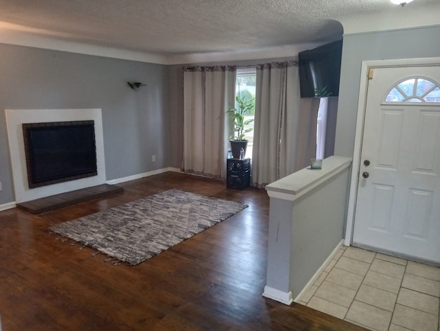 entryway featuring hardwood / wood-style flooring, a textured ceiling, and a wealth of natural light