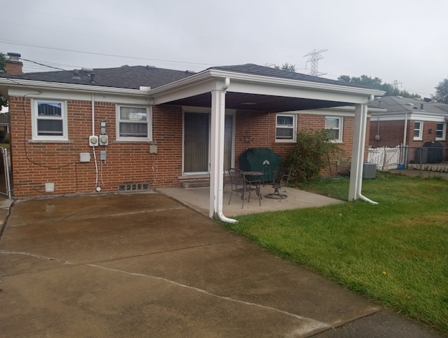 rear view of property featuring a patio area and a yard