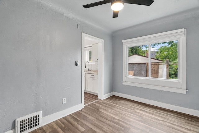 spare room featuring light hardwood / wood-style floors and ceiling fan