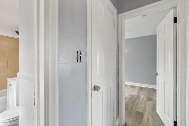 hallway with wood-type flooring