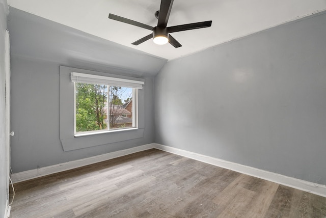 spare room with ceiling fan, wood-type flooring, and lofted ceiling