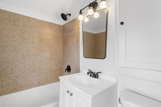 full bathroom featuring vanity, toilet, and tiled shower / bath