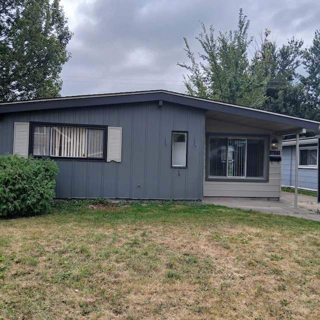 rear view of house with a lawn