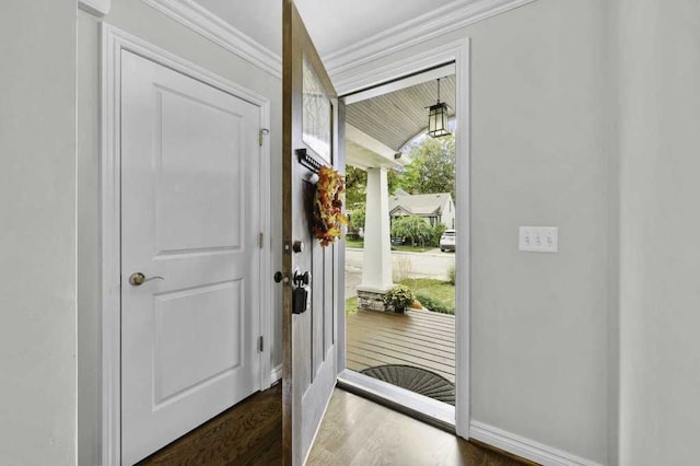 doorway featuring dark hardwood / wood-style floors and ornamental molding