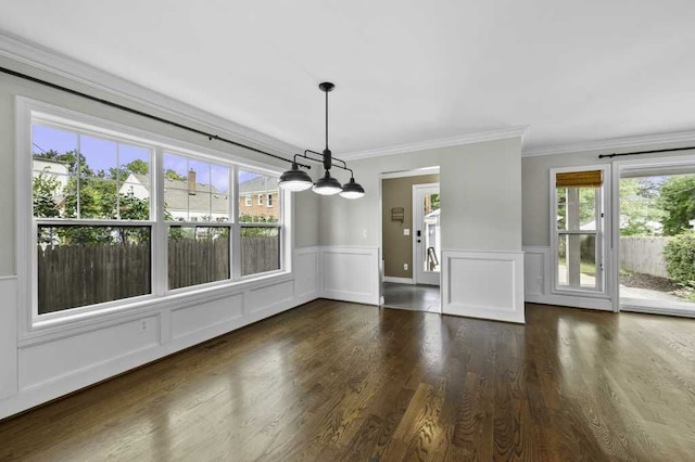 unfurnished dining area with ornamental molding, dark hardwood / wood-style floors, and a healthy amount of sunlight