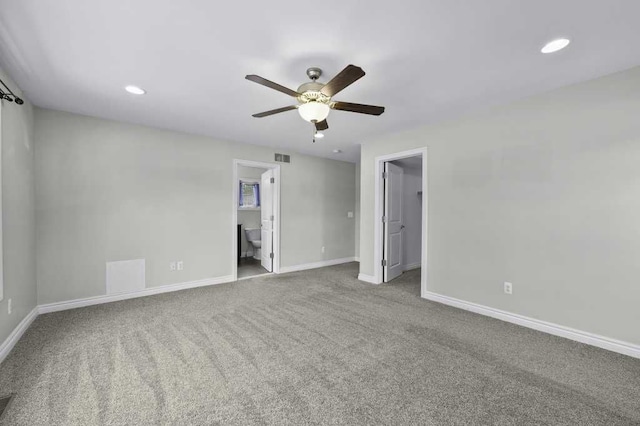 carpeted spare room featuring ceiling fan