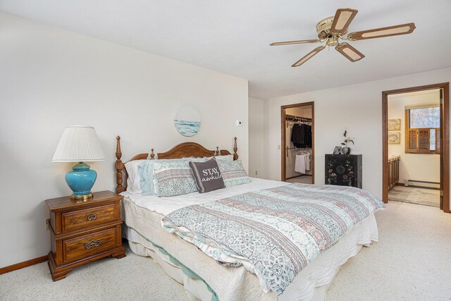 1875 Edwin Dr, Wayland, MI 49348 - bedroom with a baseboard heating unit, light carpet, a walk in closet, a closet, and ensuite bathroom
