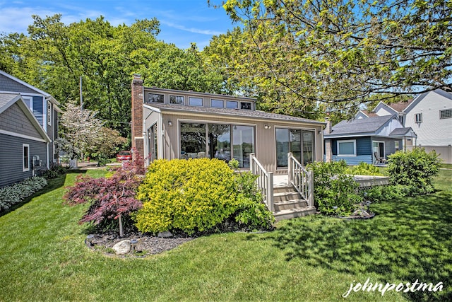 1875 Edwin Dr, Wayland, MI 49348 - view of front of home with board and batten siding, a front yard, and a chimney