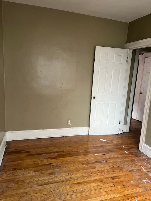 unfurnished room with hardwood / wood-style flooring