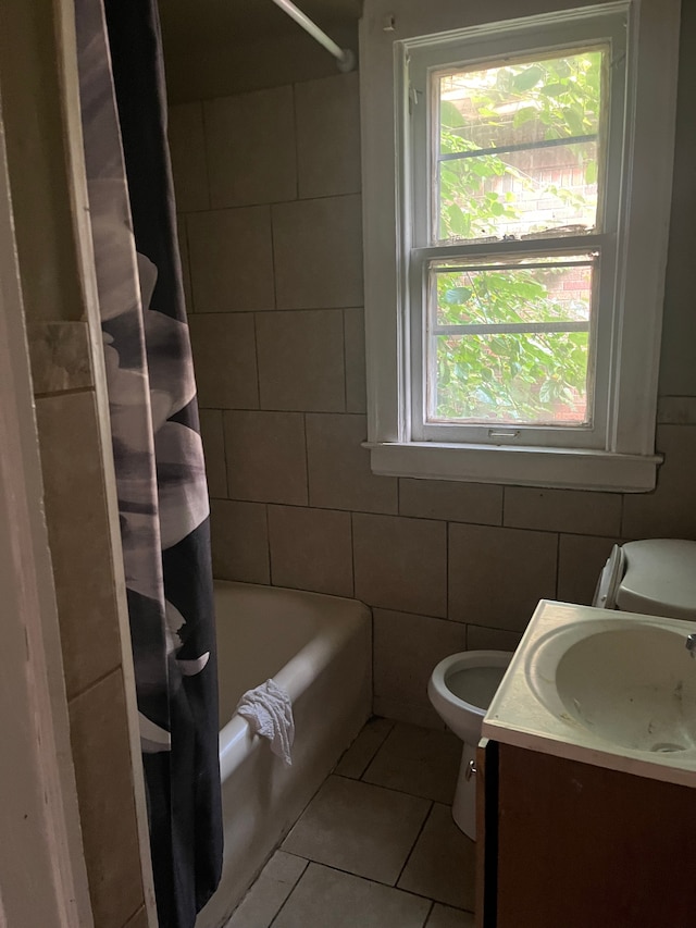 full bathroom with vanity, tile patterned floors, shower / bath combination with curtain, toilet, and tile walls