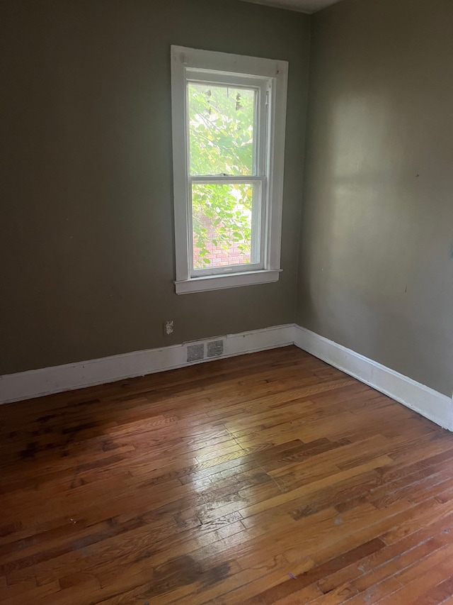 empty room featuring dark wood-type flooring