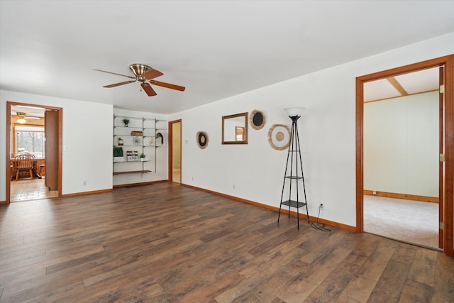 unfurnished living room with dark hardwood / wood-style floors and ceiling fan