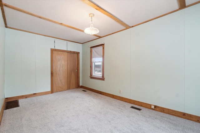 carpeted empty room with ornamental molding