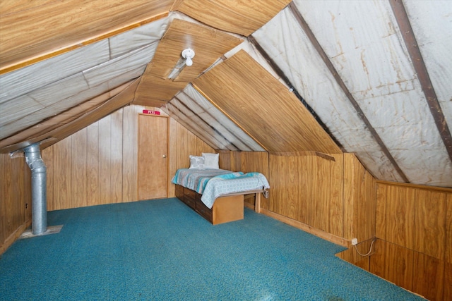 bonus room featuring lofted ceiling and wood walls