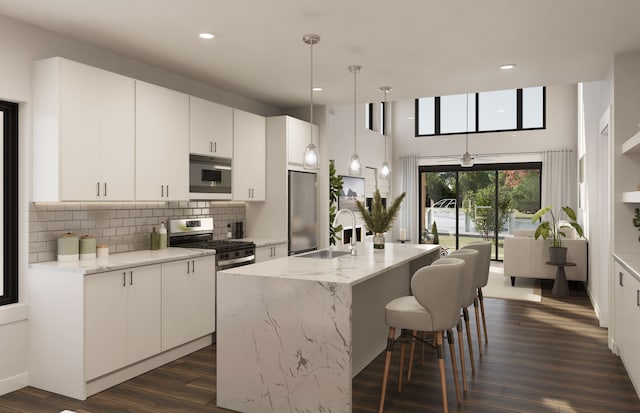 267 Keelson Dr, Detroit, MI 48215 - kitchen featuring appliances with stainless steel finishes, a sink, dark wood-type flooring, a breakfast bar, and decorative backsplash