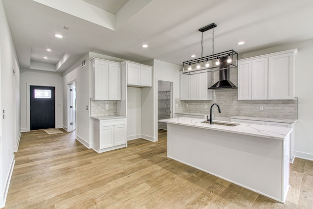 kitchen with light hardwood / wood-style flooring, white cabinetry, and sink