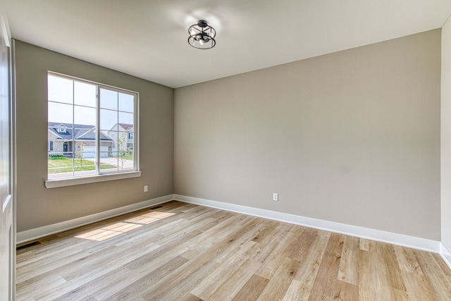 empty room with light hardwood / wood-style flooring