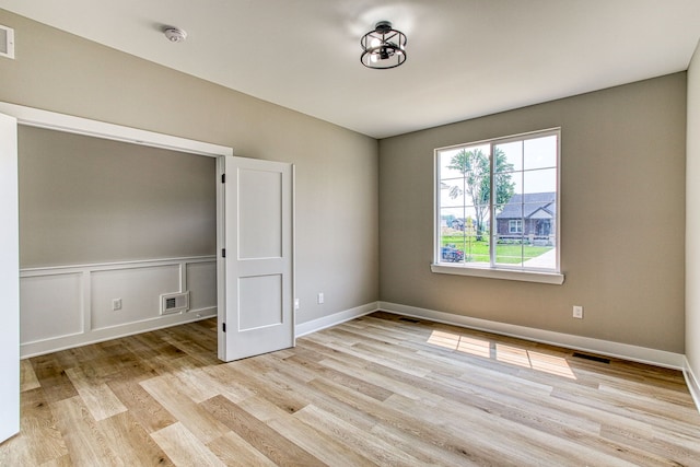 spare room with light wood-type flooring