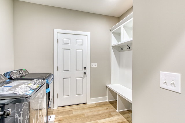 clothes washing area featuring light hardwood / wood-style flooring and independent washer and dryer