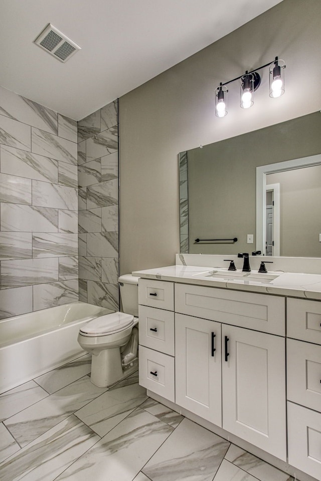 full bathroom with toilet, vanity, and tiled shower / bath