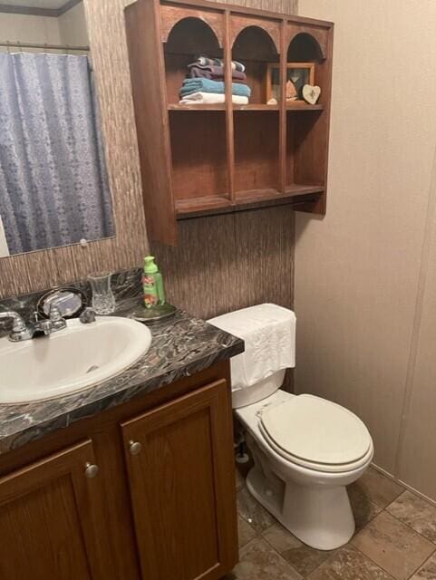 bathroom featuring vanity and toilet